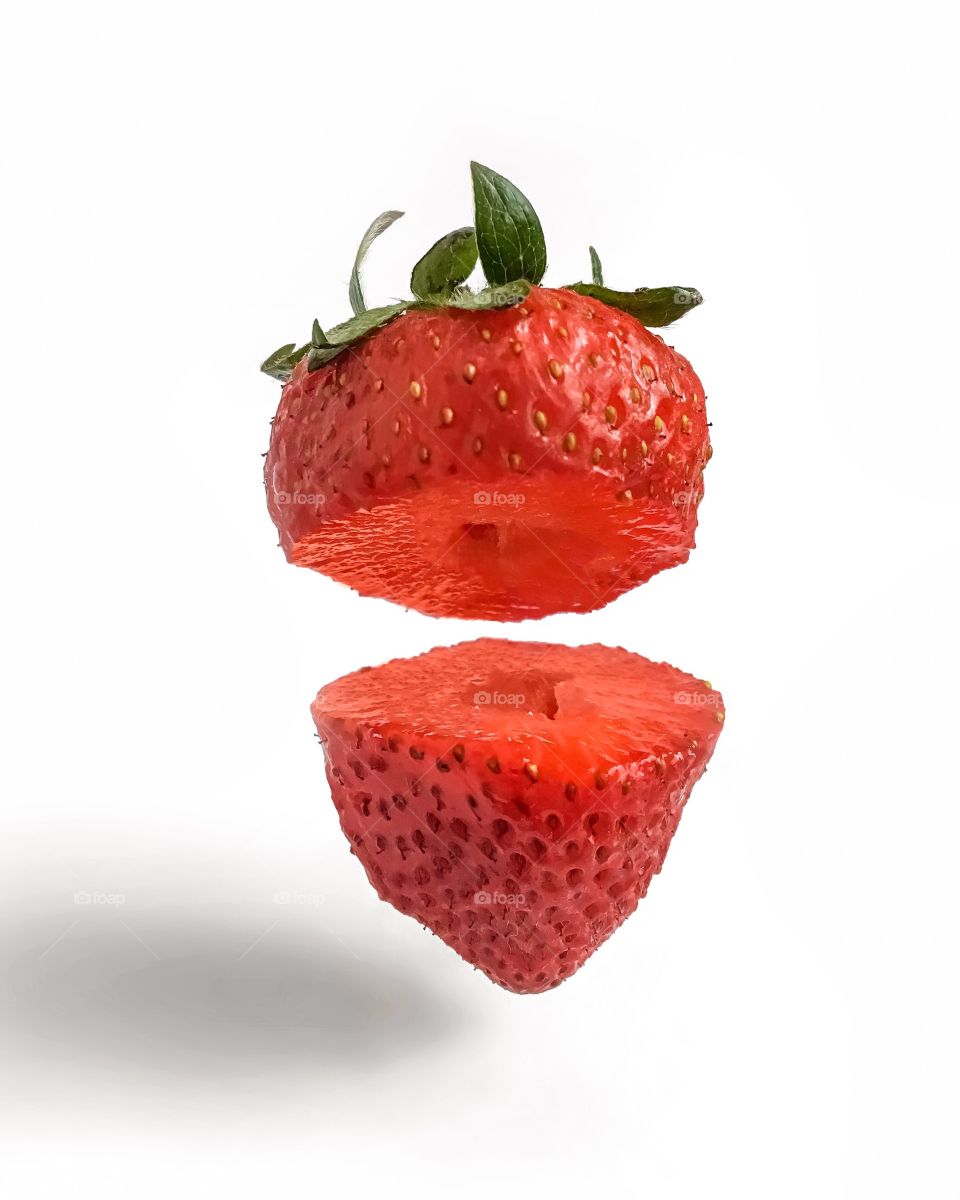 A cut red strawberry on white background 
