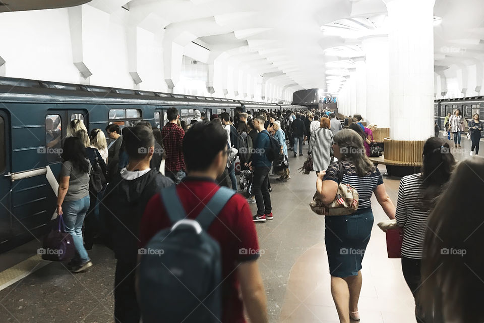 Crowd of people at subway station waiting for a train arrival during the rush hour