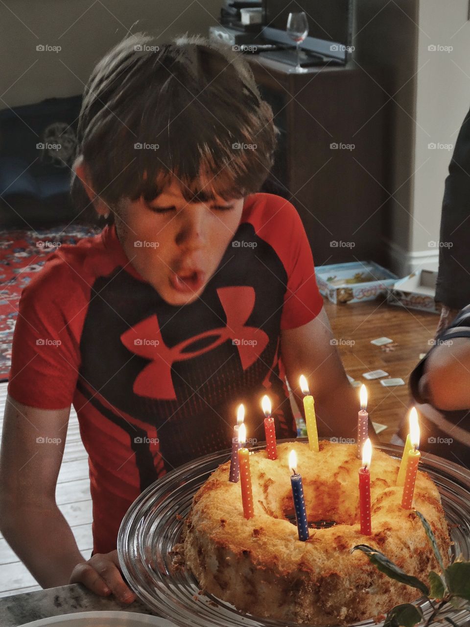 Birthday Wish. Young Boy Blowing Out Birthday Candles
