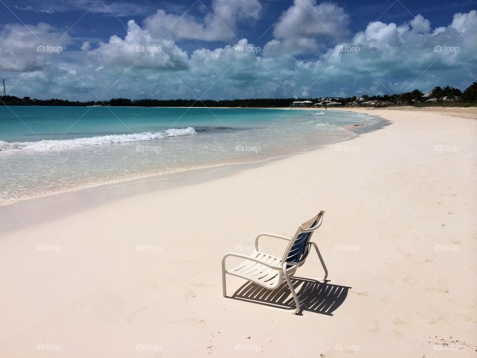 Relaxation awaits: a lone beach chair on the beach