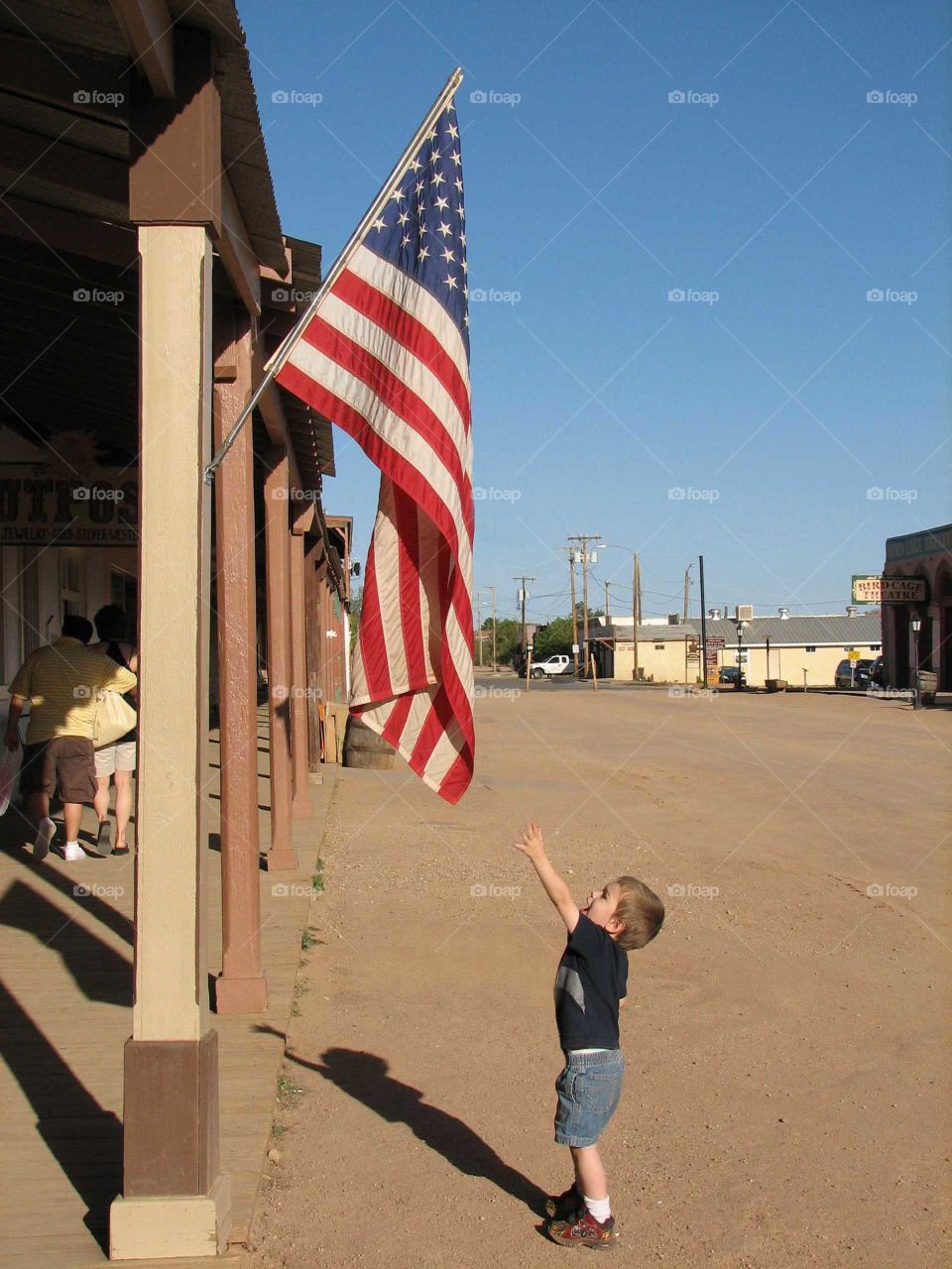 Child grabbing for the US Flag.