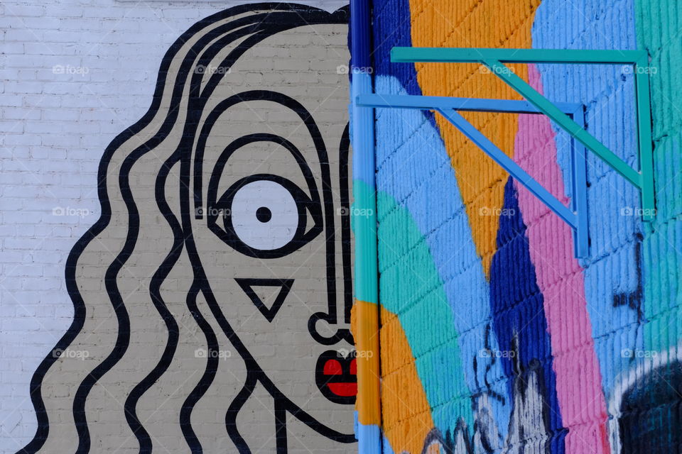 This is two walls with different art graffiti on them in the city of Montreal. 