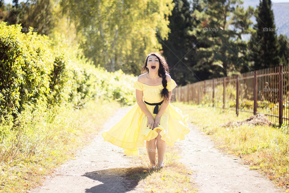 Portrait of a woman standing on dirt track