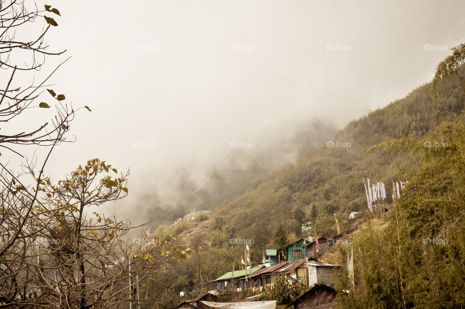 Fantastic beauty of town in hill slope of himalayas mountain, Dramatic cliffs surrond the town in a foggy winter day. Darjeeling West Bengal India. Stunning Backdrop