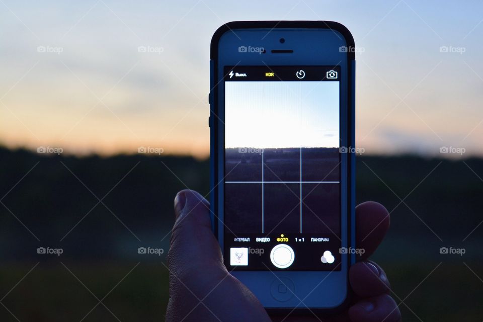 Summer evening moment taking photo with smartphone
