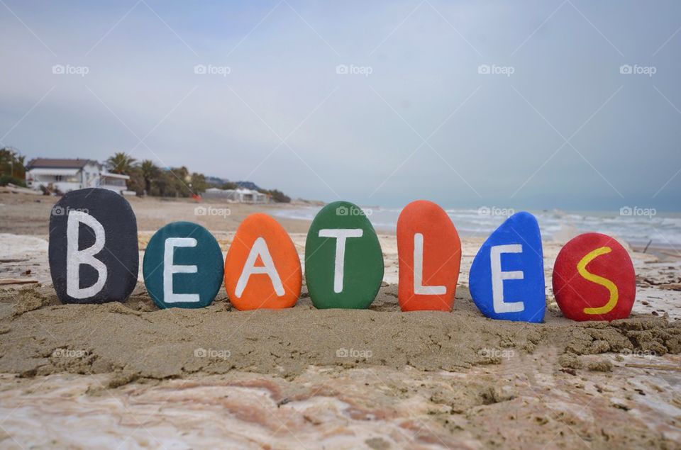 Beatles, colourful stones composition on the beach