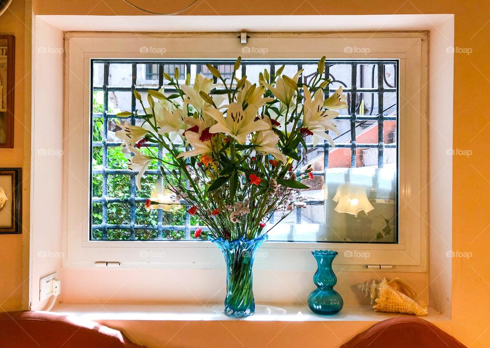 Bouquet of white lilies in restaurant in Venice Italy 