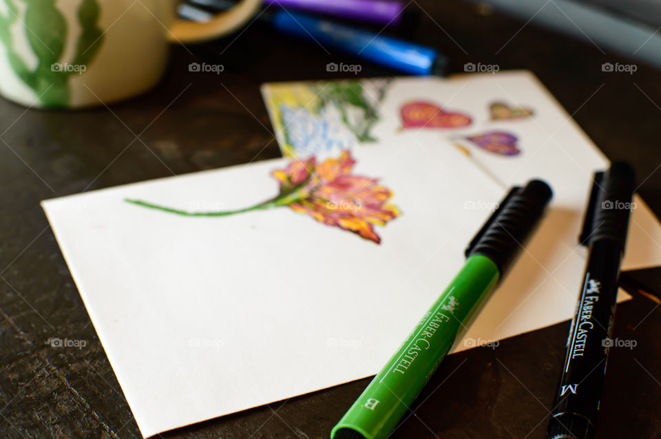Making home made cards and place cards with Faber-Castell PITT artist pen Olive green color wishing for spring with coffee mug and colorful pens on rustic wood conceptual background photography 