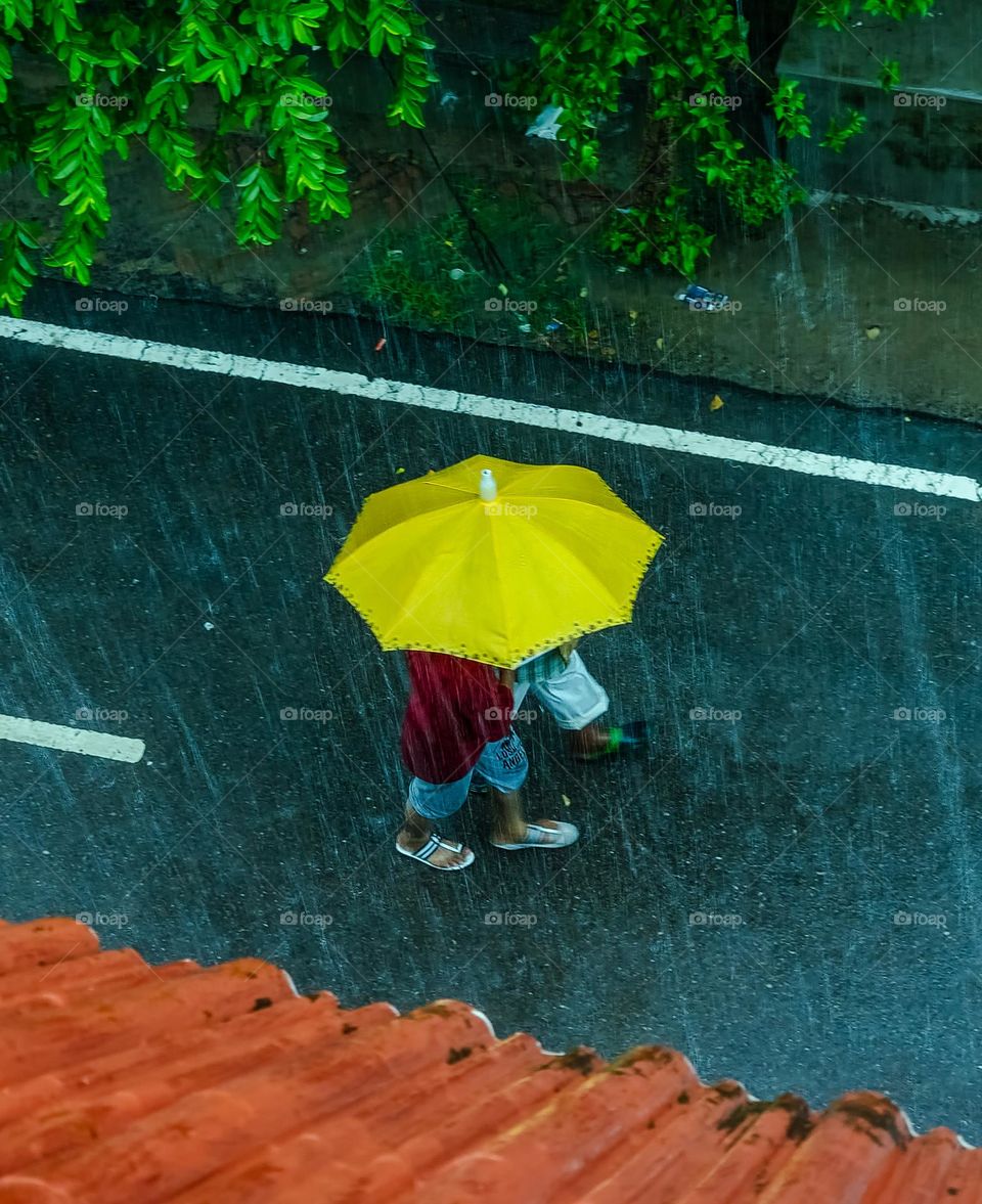 people walking in rain with umbrella