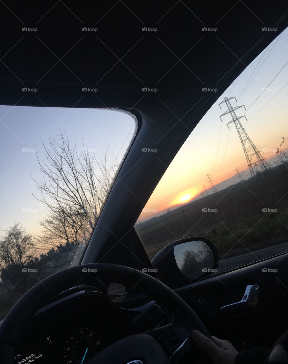 A beautiful landscape of the sunrise out of a car windscreen taken in Kent. Would look stunning in a frame or on a canvas