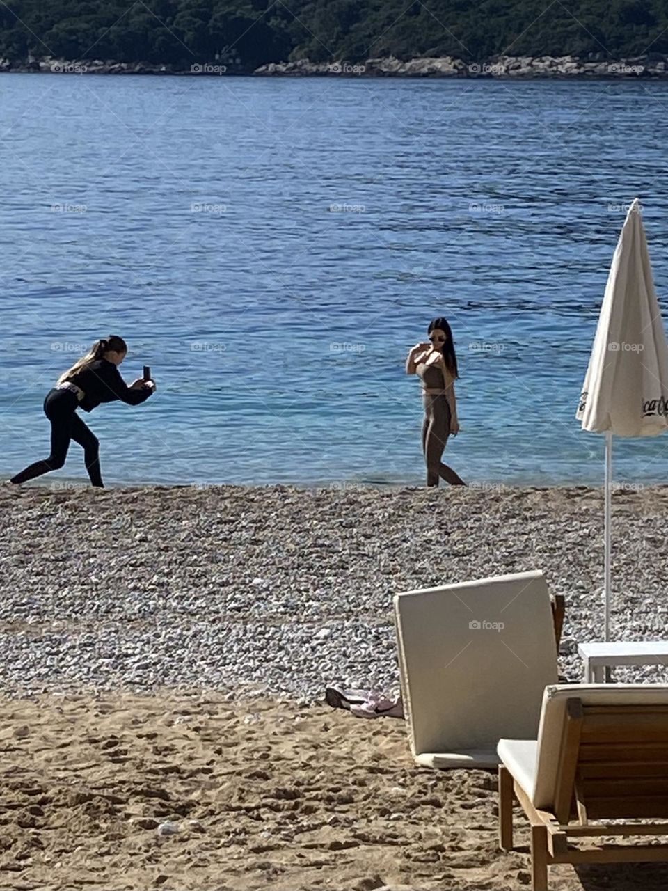 Two young girls filming a spontaneous video while on their spring vacation on the Croatian Coast.