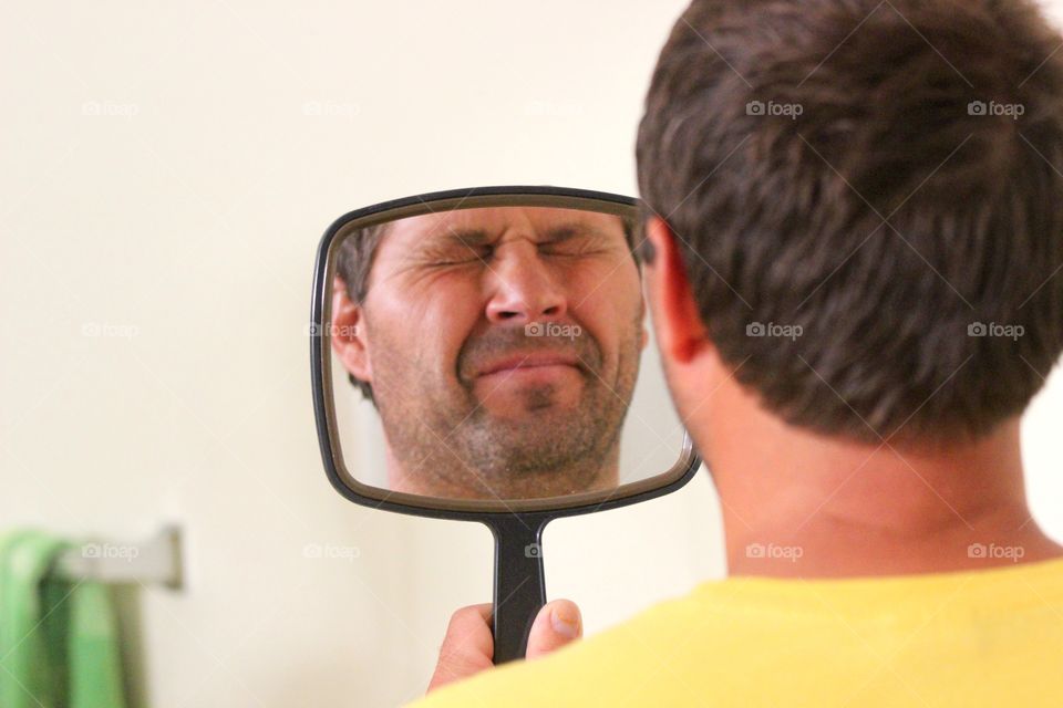 Reflection of a man's face on mirror