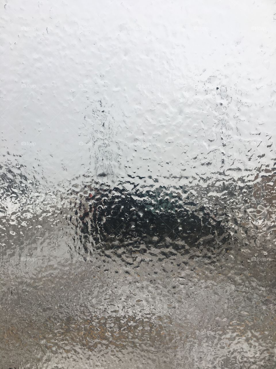 Car window covered in ice after freezing rain 