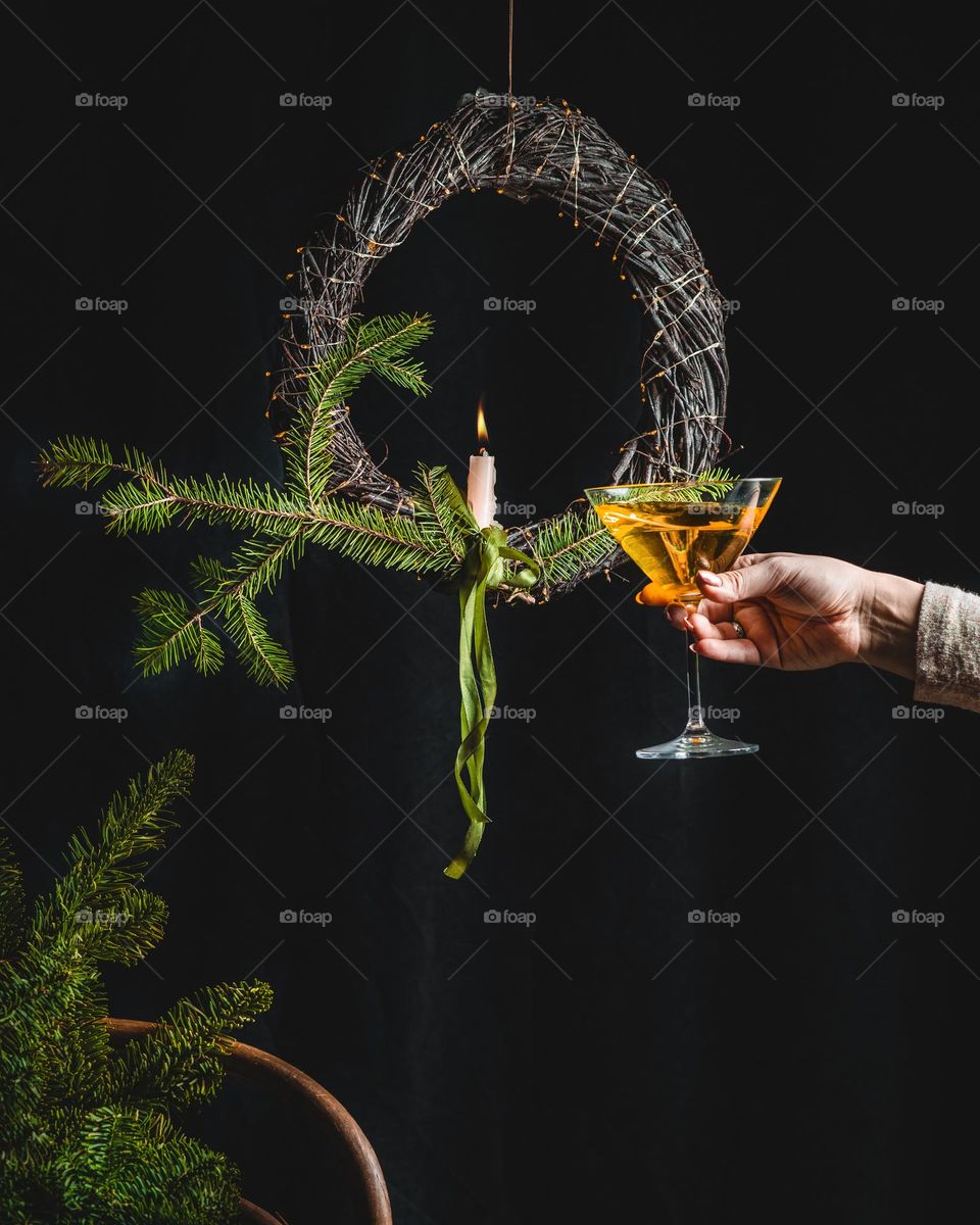 still life with Christmas wreath and glass of wine