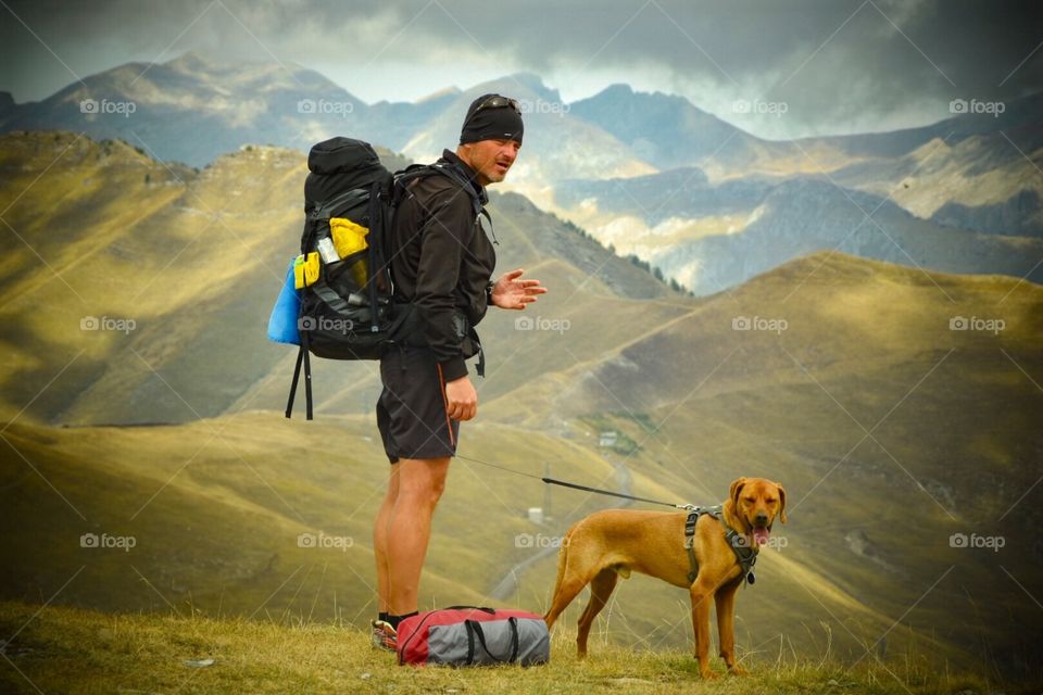 hiker with dog, italian alps.