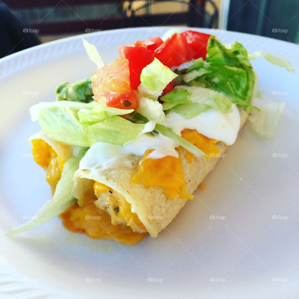 Chicken and cheese rolled enchiladas topped with sour cream,lettuce and fresh tomatoes! 