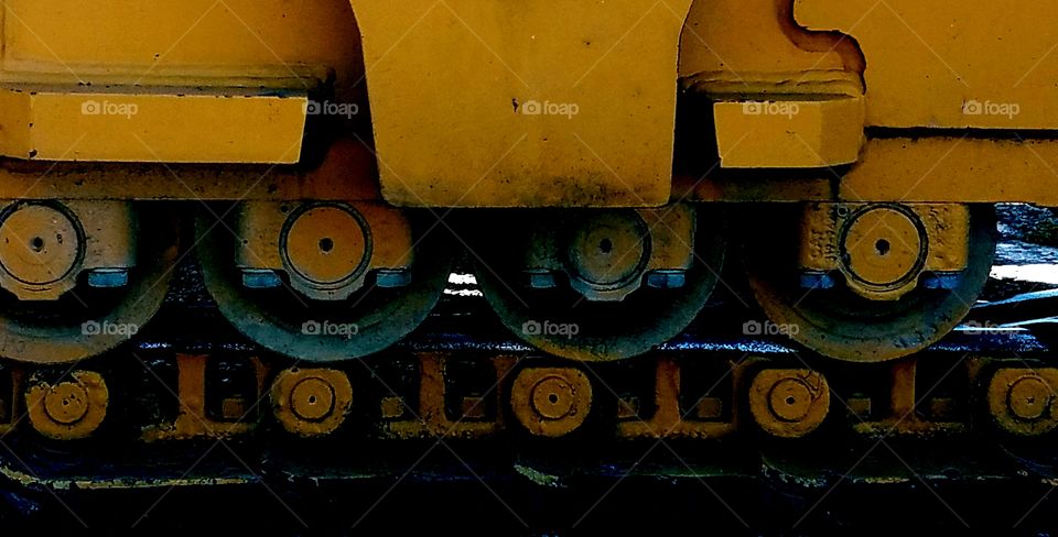 A closeup at the wheels of a large construction machine