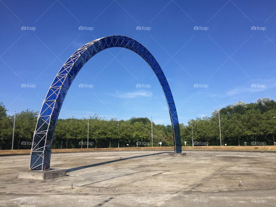 Blue metal arch in the middle of the road