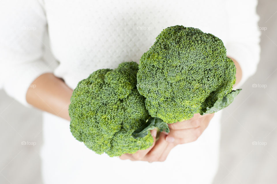 woman holding broccoli