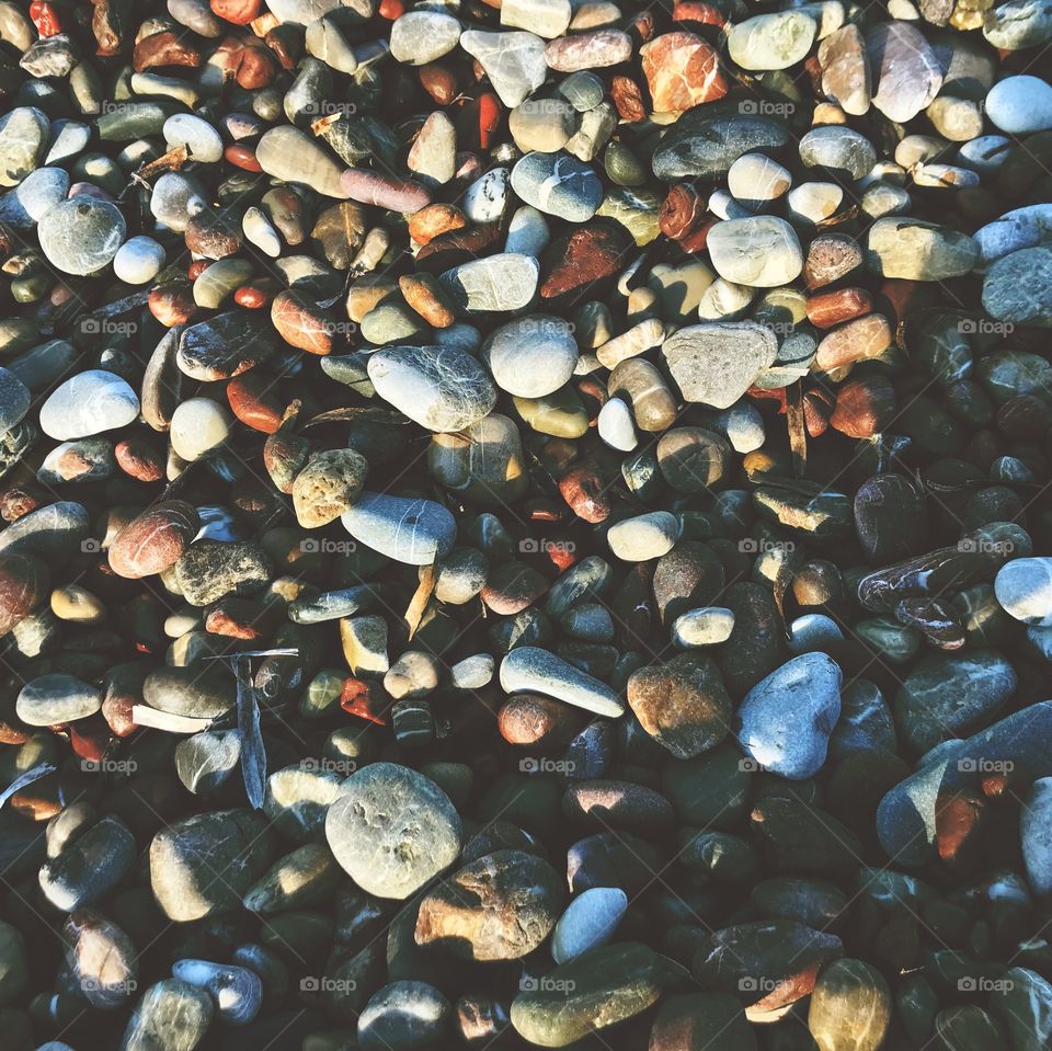 Beach pebbles in warm earthy hues, from the gorgeous island of Kythera in Greece 