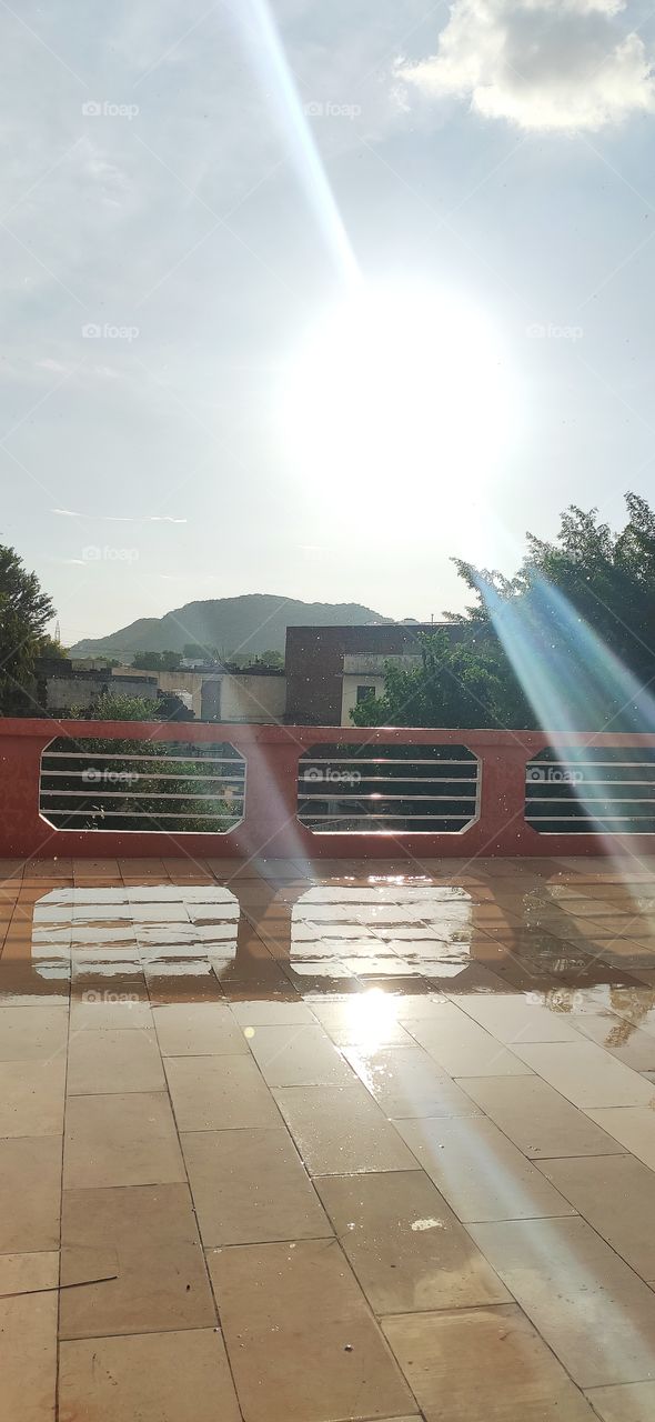 Rainy day on rooftop of our bungalow with Sun on 1 side and rainbow on opposite side, mighty day to dance in rain and to be engraved in memory. Seeing double and top of it even the reflection of Sun have it's own rays,blessed to witness God's miracle