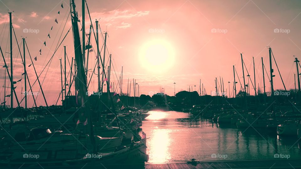 Sunset at Marina near Belém Tower and Tejo River with the boats silhouette in the First plan.