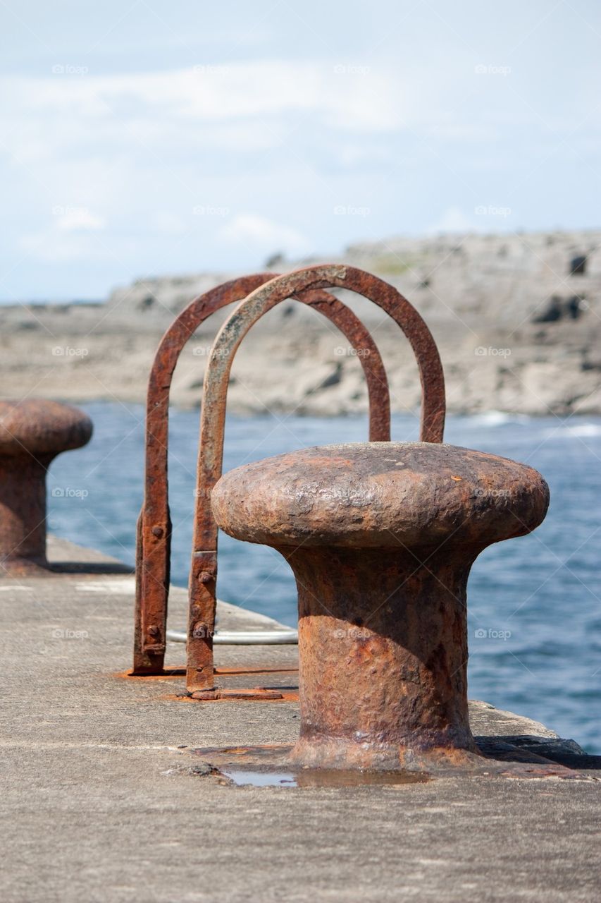 View of rusty bollard on dock