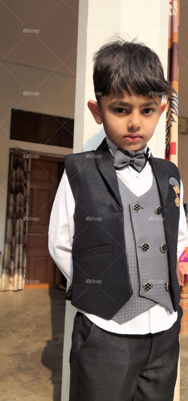 Young boy standing in anger and posing for the camera