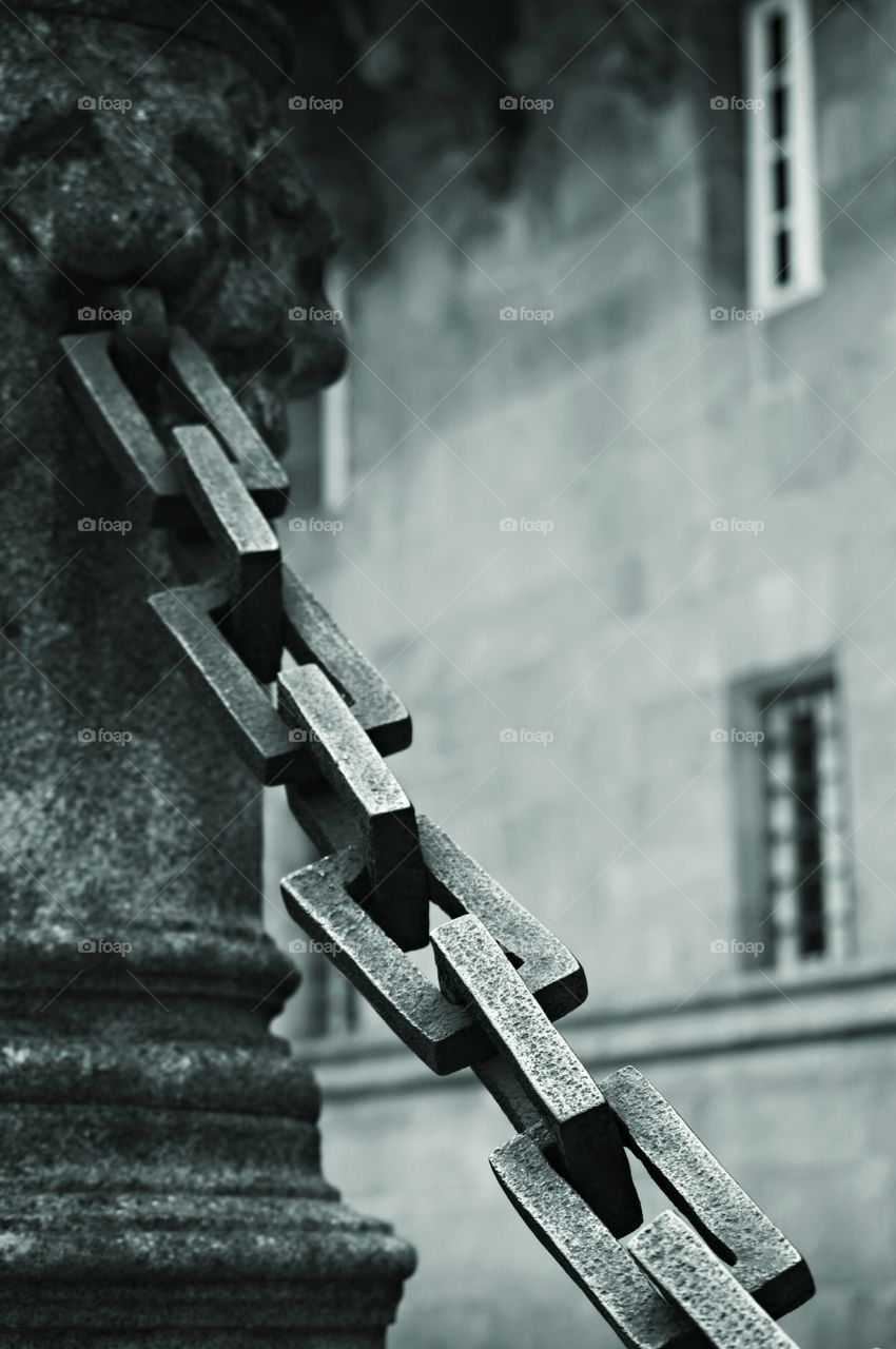 Stone pillar and chain. Stone pillar and chain at the entrance to Hostal dos Reis Católicos, Santiago de Compostela, Spain