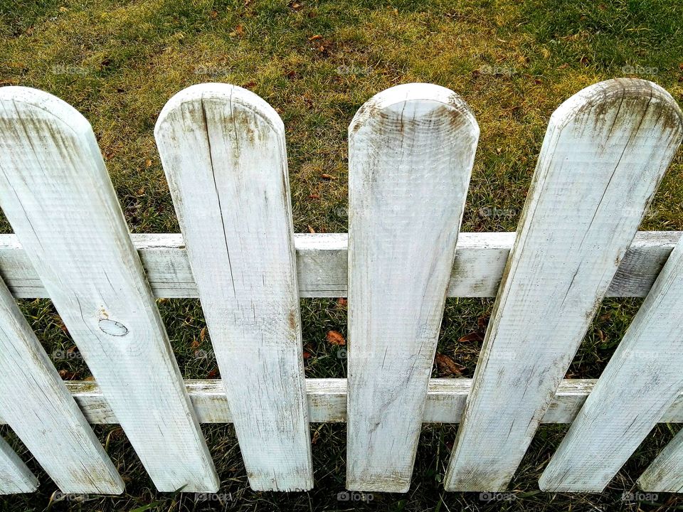 white pucket fence in front of the house