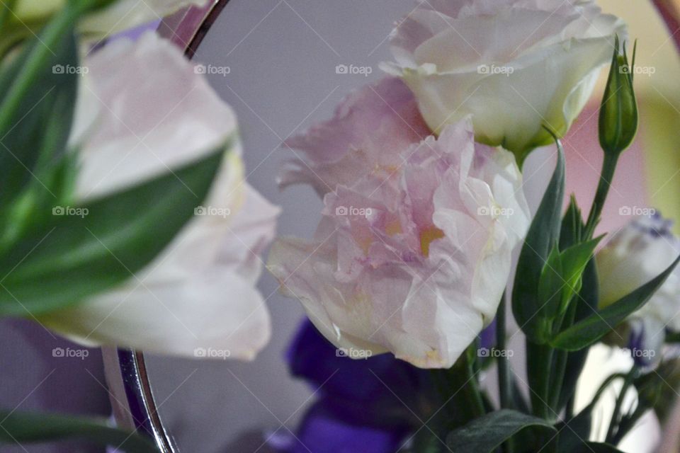 Beautiful flowers in a vase and with a mirror