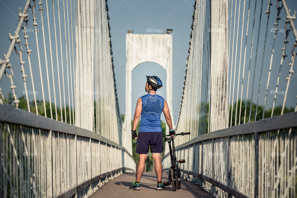 Man with bicycle in the bridge 