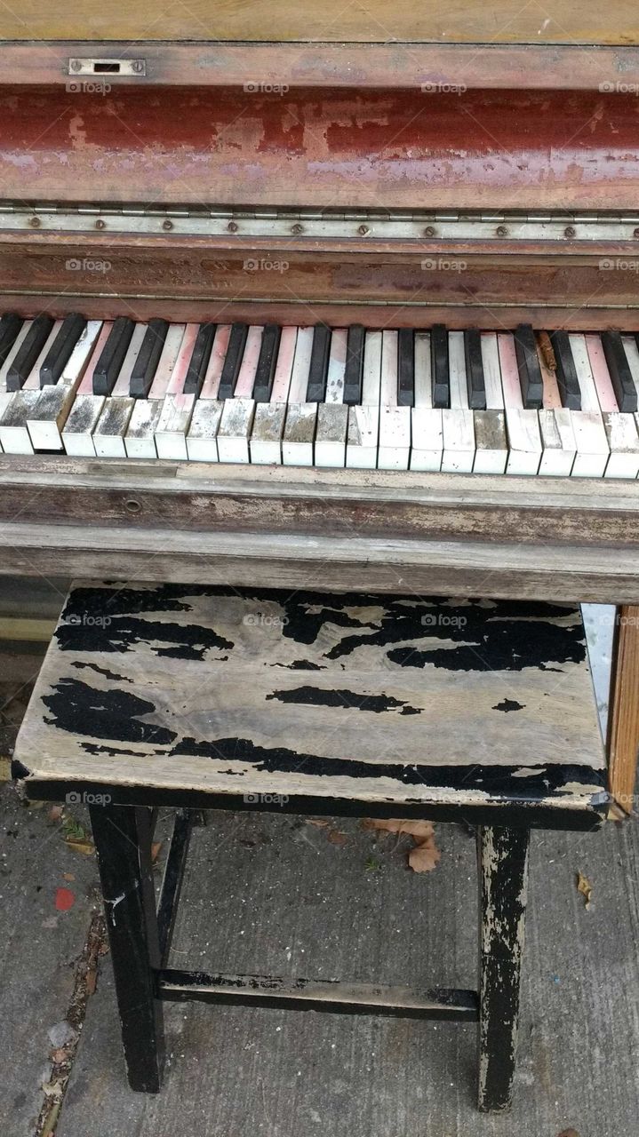 Close-up of old piano and stool
