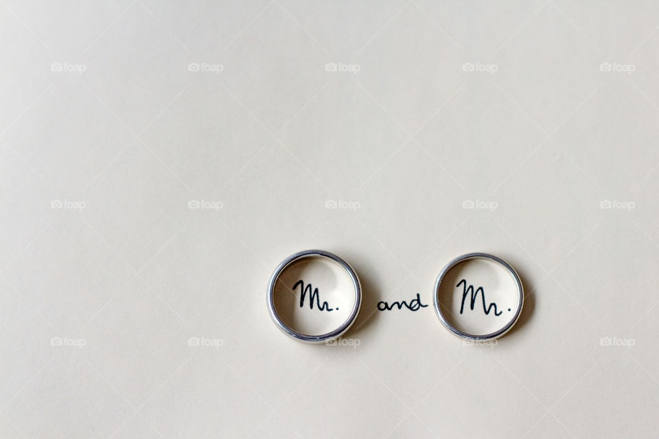 Men's rings at a gay wedding with the words Mr written inside