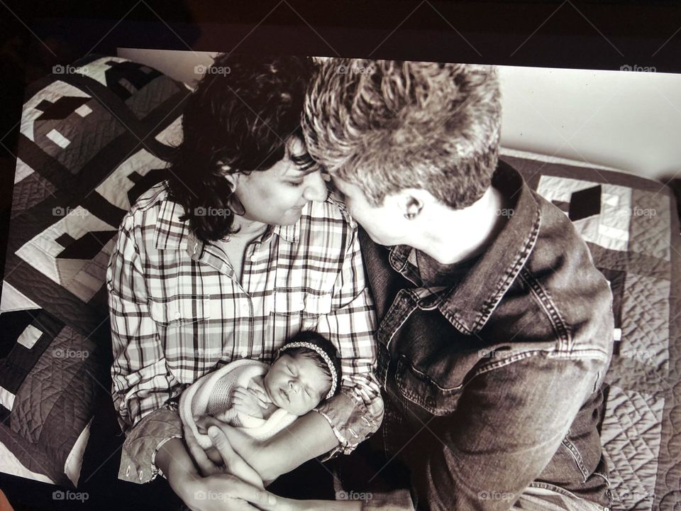 Tender moments with newborn baby, two mothers with baby girl, view from above, two loving parents with baby, newborn baby snuggles