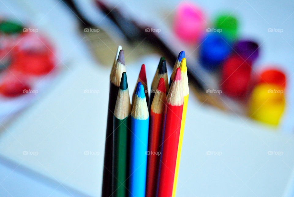 Art supplies, colored pencils, paintbrushes, paint, sketch book, watercolor pad, palette