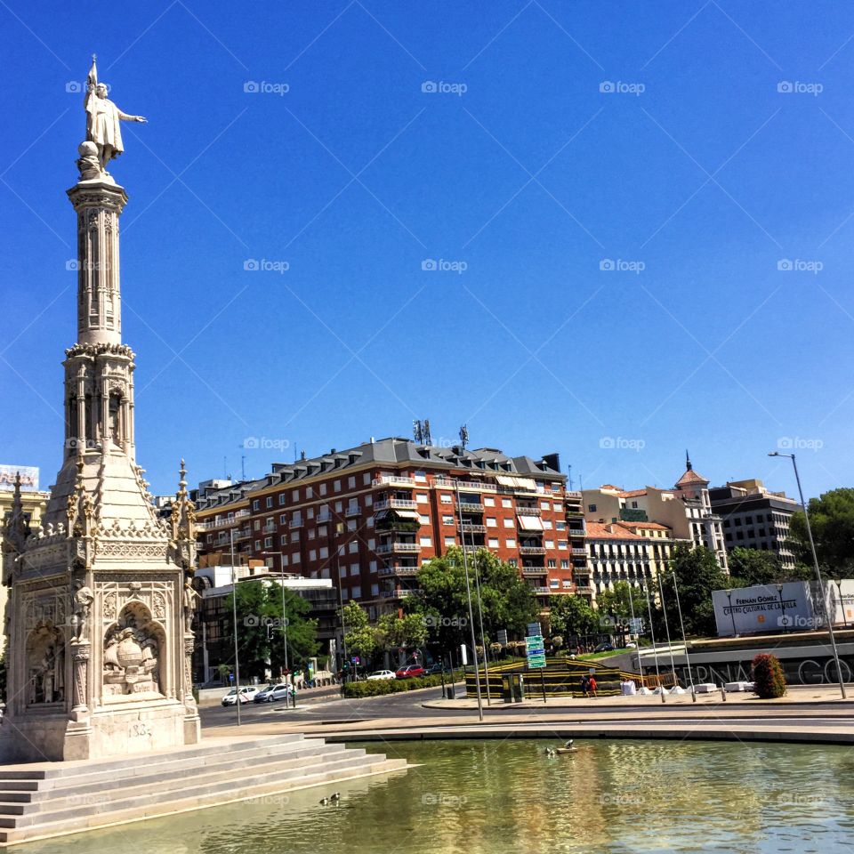 The statue of Christopher Columbus by a fountain in Madrid 