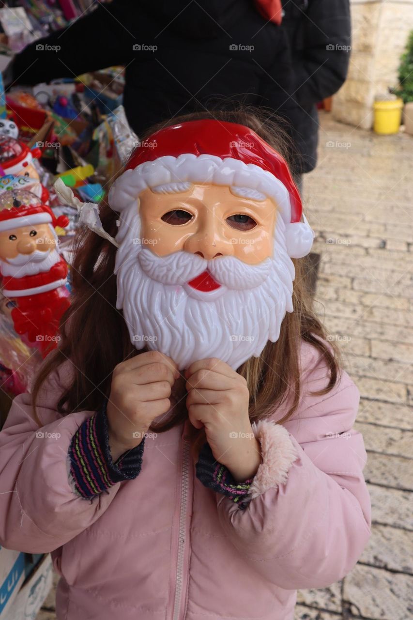 A girl with Santa mask