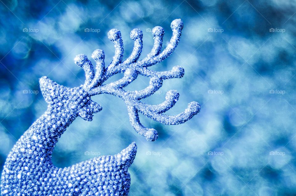 Reindeer. Is sparkly blue Christmas reindeer against blue background.