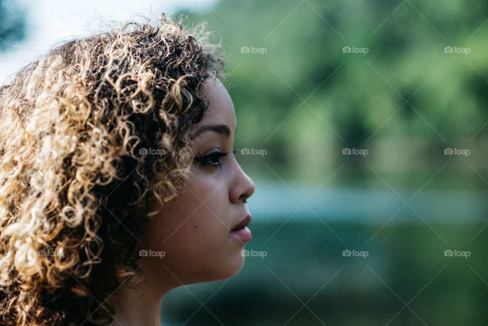 Side view of a curly hair woman