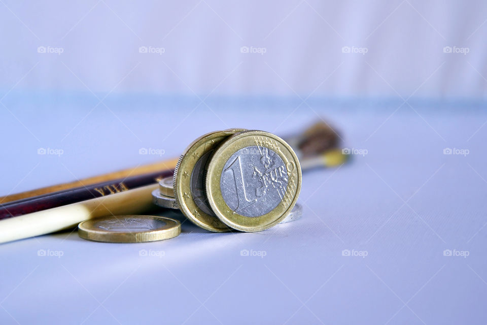 Close-up of a euro coins and paintbrush