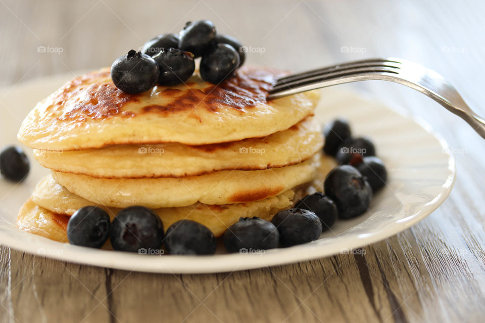 Pile of freshly made golden pancakes on a plate