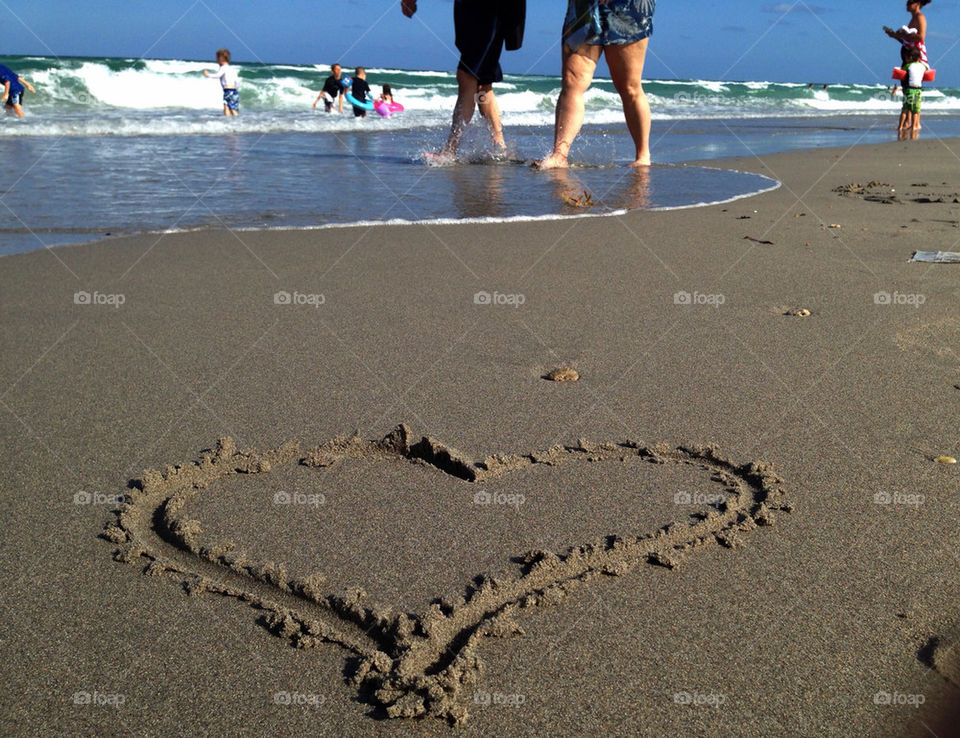 Couple walking on beach, Hollywood Beach, Florida