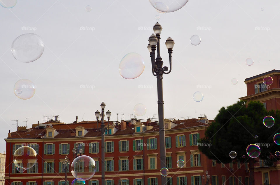 Bubbles in foreground of view of Place Massena in Nice, France.