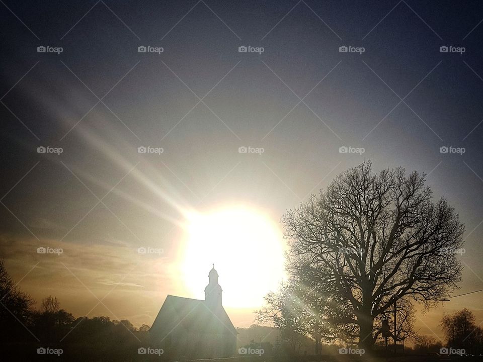 church in front of sun