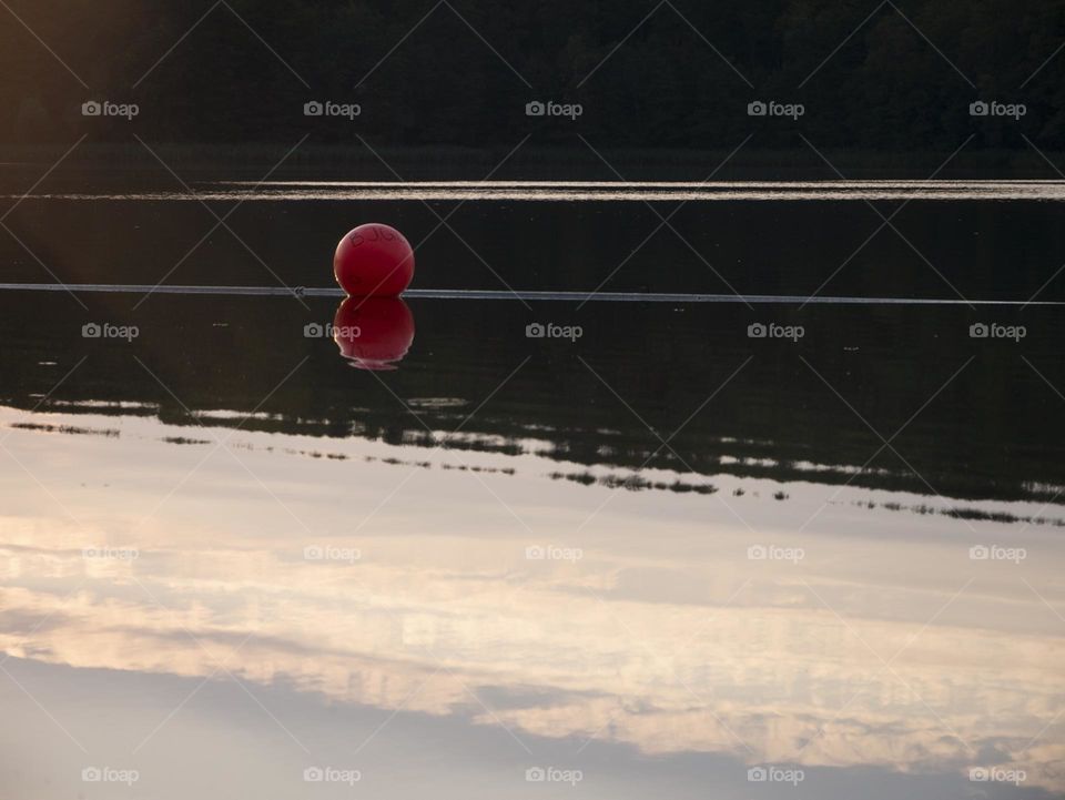 Red ball floating on the lake