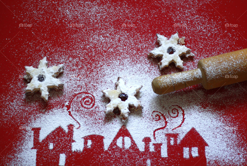 Home made cookies in stars shape, houses decoration of powdered sugar