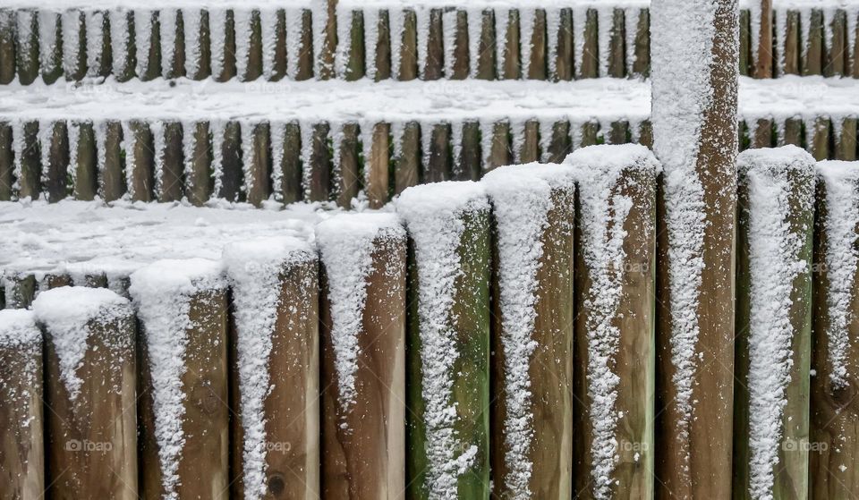 Snow on fence posts in triangular patterns