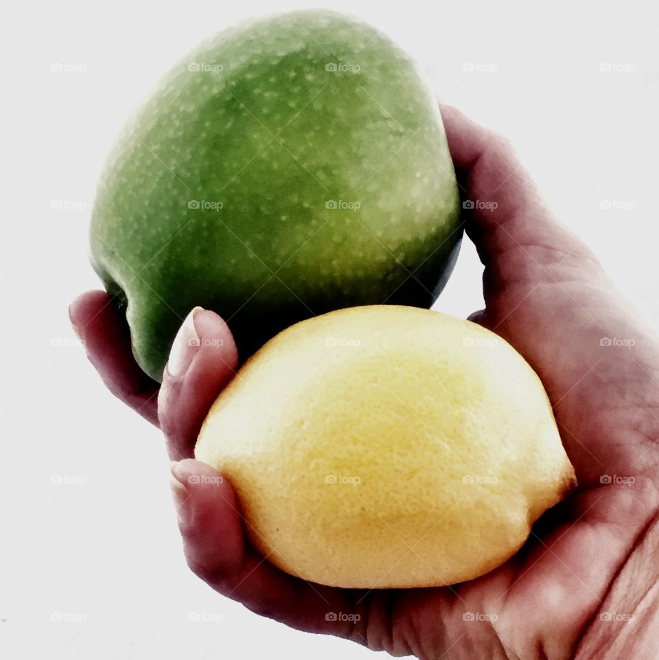Person's hand holding fruits