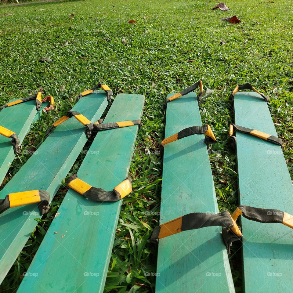 a traditional game tool from Indonesia "clogs" made of long wooden boards and rubber straps that rely on team cohesiveness